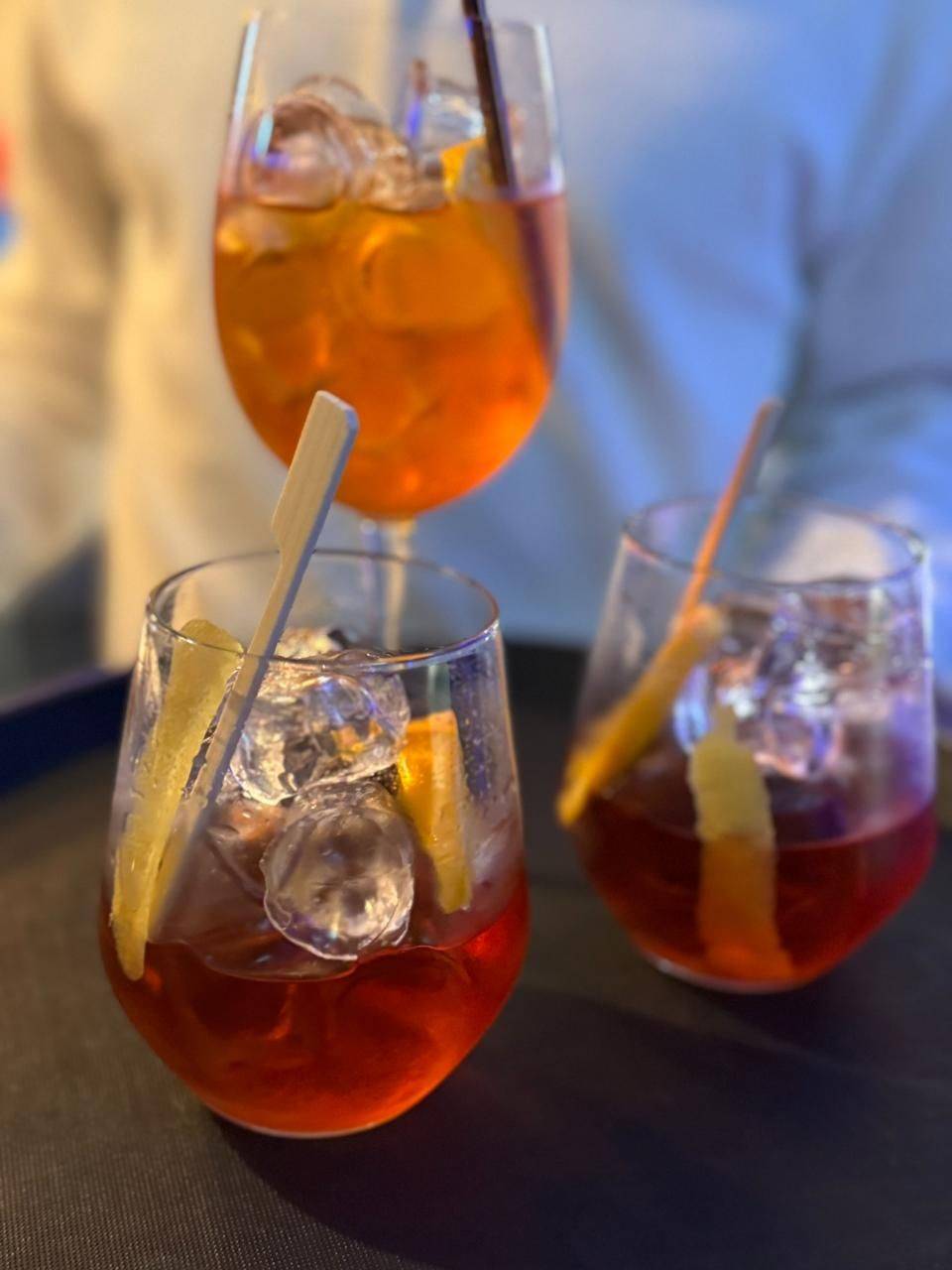 Three cocktails with ice and orange slices